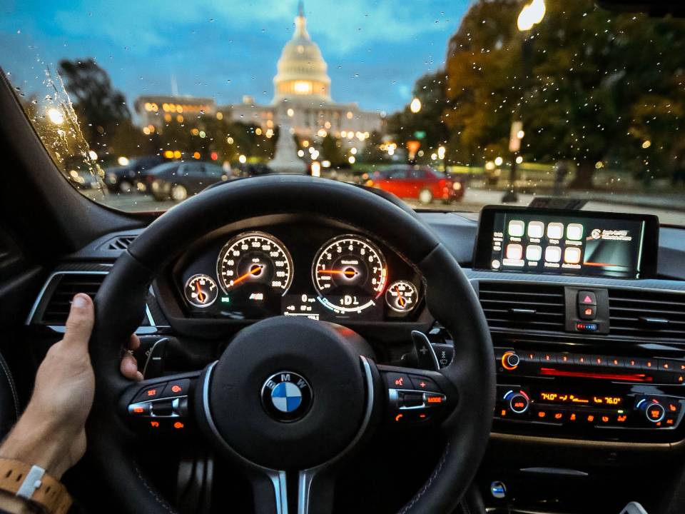 Person Holding Bmw Steering Wheel